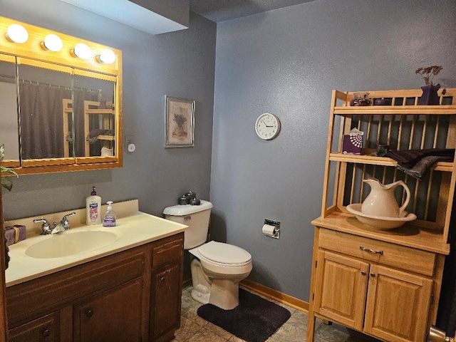 1991 190th Ave, Osceola, IA 50213 - full bathroom with toilet, vanity, tile patterned floors, and baseboards