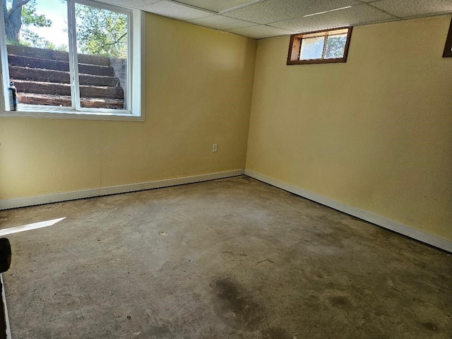 1991 190th Ave, Osceola, IA 50213 - spare room with baseboards, concrete floors, and a paneled ceiling