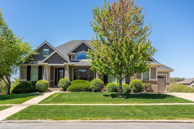 9257 Sugar Creek Dr, West Des Moines, IA 50266 - craftsman-style home featuring stone siding, a front yard, a garage, and driveway