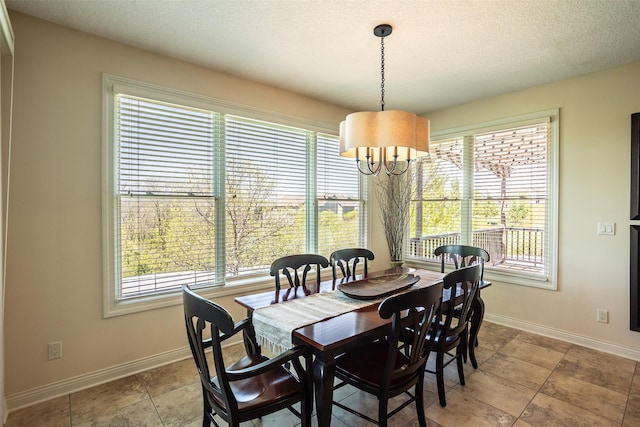 9257 Sugar Creek Dr, West Des Moines, IA 50266 - dining area with plenty of natural light, a chandelier, and baseboards
