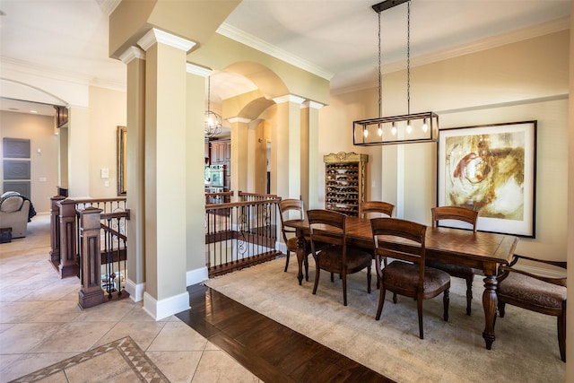 9257 Sugar Creek Dr, West Des Moines, IA 50266 - dining space with decorative columns, ornamental molding, baseboards, light tile patterned floors, and inlaid floor details