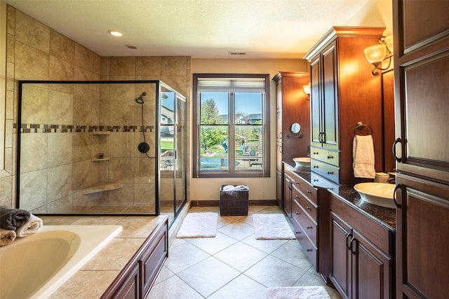 9257 Sugar Creek Dr, West Des Moines, IA 50266 - bathroom featuring a shower stall, vanity, tile patterned floors, a garden tub, and baseboards