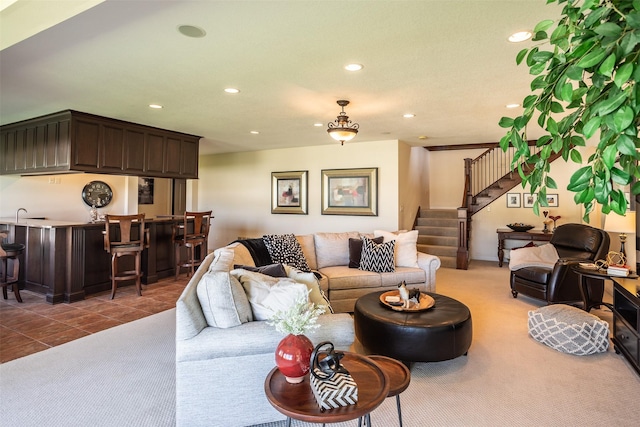 9257 Sugar Creek Dr, West Des Moines, IA 50266 - carpeted living room with recessed lighting, stairway, bar with sink, and tile patterned floors
