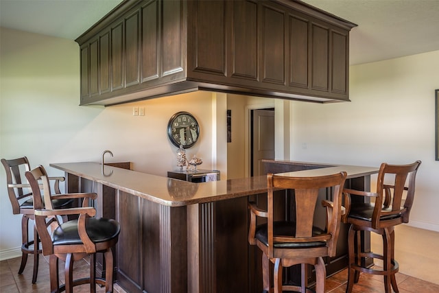 9257 Sugar Creek Dr, West Des Moines, IA 50266 - indoor wet bar featuring tile patterned floors and baseboards