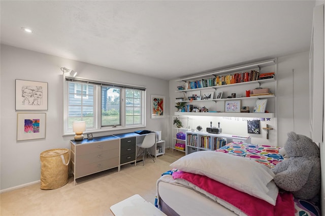 bedroom featuring light colored carpet and baseboards