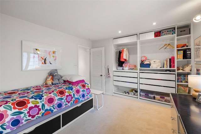 carpeted bedroom with a closet and recessed lighting