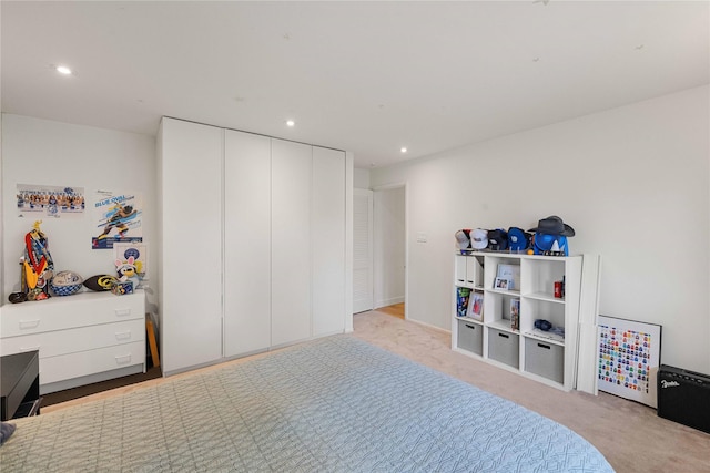 bedroom featuring recessed lighting, a closet, and carpet