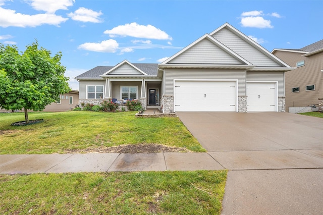 235 Emerson Ln, Waukee, IA 50263 - craftsman-style home with a garage, stone siding, concrete driveway, and a front lawn