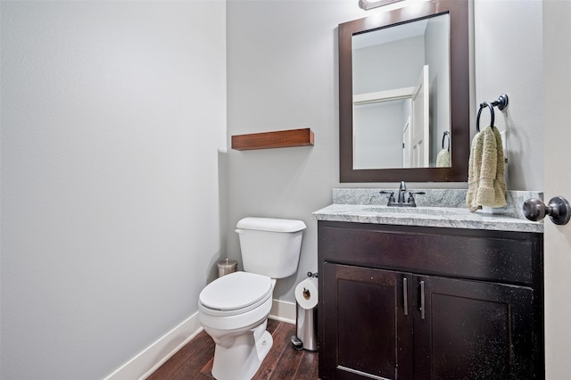 235 Emerson Ln, Waukee, IA 50263 - half bathroom featuring wood finished floors, toilet, vanity, and baseboards