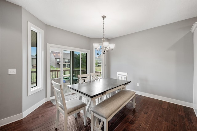 235 Emerson Ln, Waukee, IA 50263 - dining area with a chandelier, dark wood finished floors, and baseboards