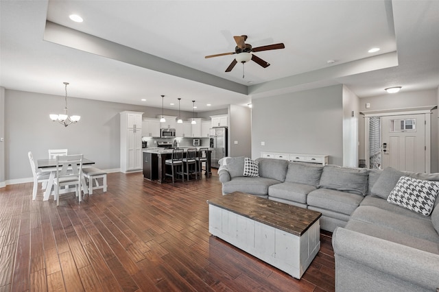 235 Emerson Ln, Waukee, IA 50263 - living room featuring ceiling fan, dark wood-style floors, recessed lighting, a chandelier, and baseboards