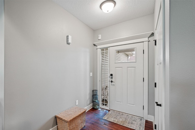 235 Emerson Ln, Waukee, IA 50263 - entryway featuring baseboards, dark wood-style flooring, and a textured ceiling
