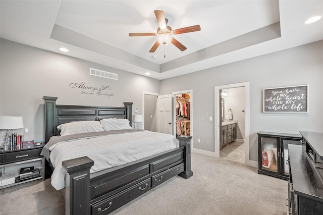 235 Emerson Ln, Waukee, IA 50263 - bedroom with light carpet, recessed lighting, baseboards, a walk in closet, and a raised ceiling