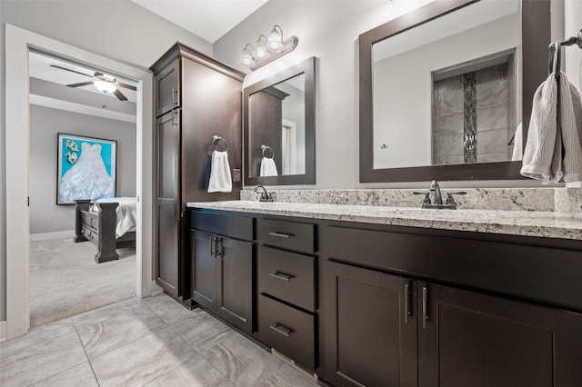 235 Emerson Ln, Waukee, IA 50263 - ensuite bathroom with double vanity, a ceiling fan, marble finish flooring, and baseboards