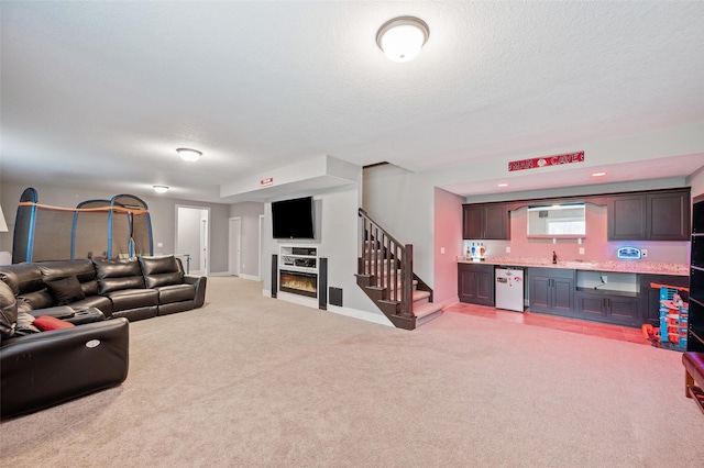 235 Emerson Ln, Waukee, IA 50263 - living room with wet bar, light carpet, a textured ceiling, stairway, and baseboards