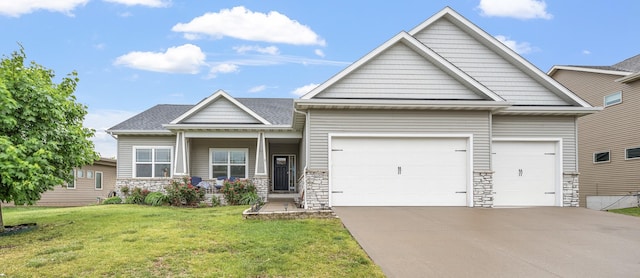 235 Emerson Ln, Waukee, IA 50263 - craftsman house with an attached garage, driveway, a front lawn, and stone siding