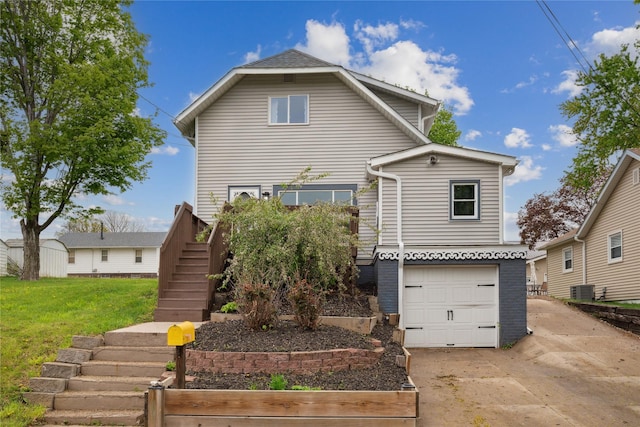 330 E 13th St N, Newton, IA 50208 - traditional-style home featuring stairway, driveway, central air condition unit, an attached garage, and a front lawn