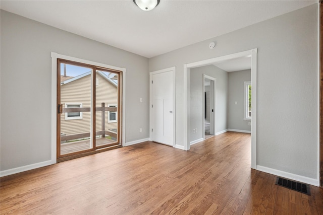330 E 13th St N, Newton, IA 50208 - empty room featuring wood finished floors and baseboards