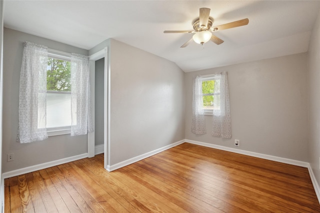 330 E 13th St N, Newton, IA 50208 - unfurnished bedroom featuring baseboards, light wood-type flooring, lofted ceiling, and ceiling fan