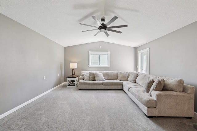 carpeted living room featuring lofted ceiling, ceiling fan, and baseboards