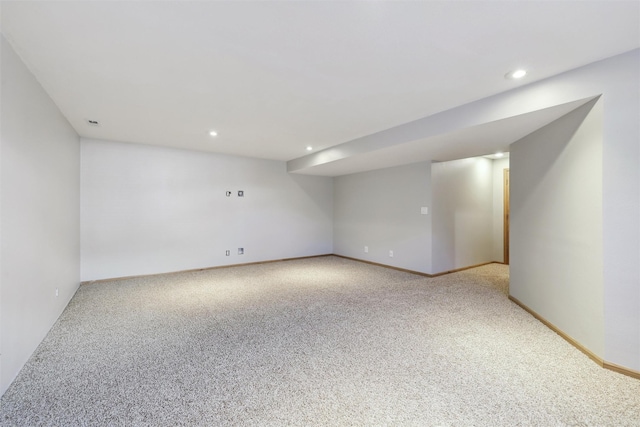 unfurnished room with light carpet, recessed lighting, and baseboards