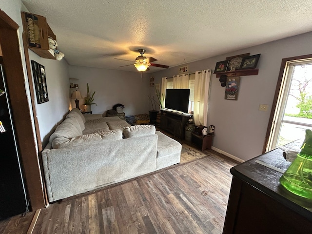 626 W Main St, Panora, IA 50216 - living area with wood finished floors, a textured ceiling, and a ceiling fan