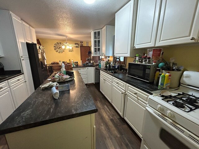 626 W Main St, Panora, IA 50216 - kitchen with black appliances, a sink, white cabinets, dark wood-type flooring, and a textured ceiling
