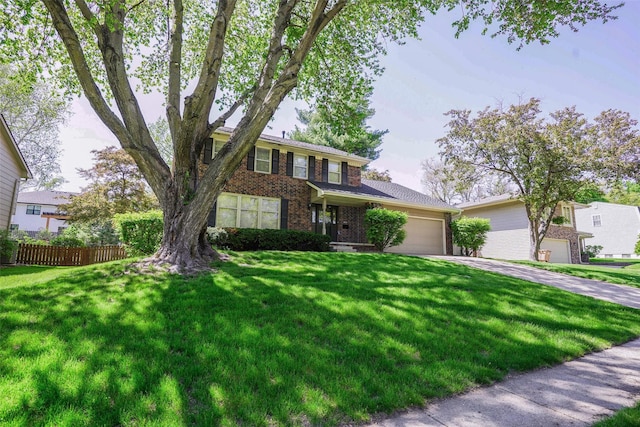 traditional home with brick siding, an attached garage, and driveway