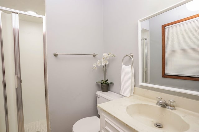 bathroom featuring a shower, toilet, and vanity
