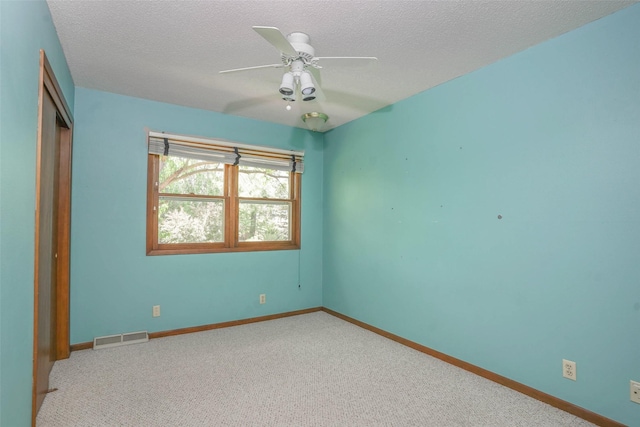 unfurnished bedroom with a closet, carpet, baseboards, and a textured ceiling