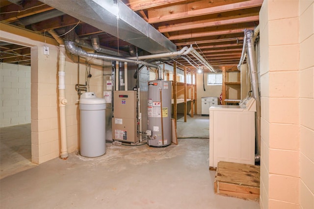 basement featuring gas water heater, a water softener, washing machine and dryer, and heating unit