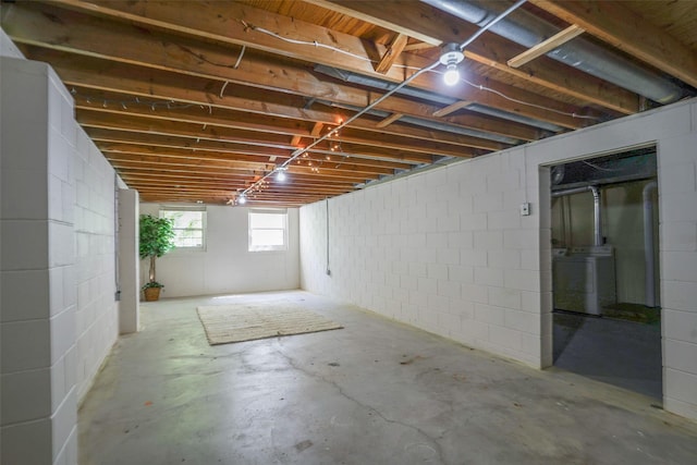 basement with washer / clothes dryer and concrete block wall