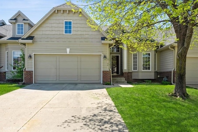 view of front of home with concrete driveway, a front lawn, brick siding, and a garage