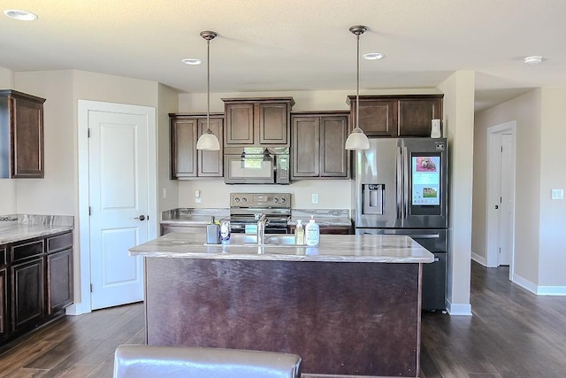 4917 Richmond Ave, Des Moines, IA 50317 - kitchen with appliances with stainless steel finishes, dark wood-style floors, dark brown cabinets, decorative light fixtures, and recessed lighting