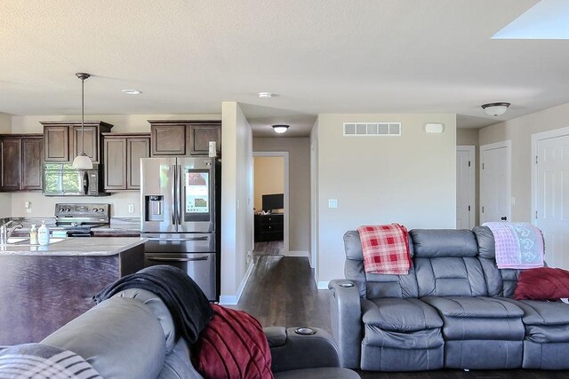 4917 Richmond Ave, Des Moines, IA 50317 - living room with dark wood-style floors and baseboards