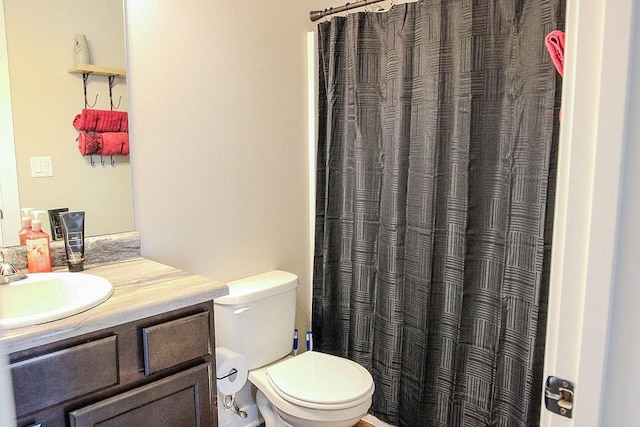 4917 Richmond Ave, Des Moines, IA 50317 - bathroom with toilet, vanity, and curtained shower