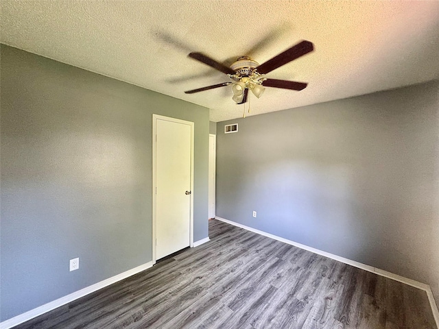 unfurnished bedroom with wood finished floors, baseboards, a textured ceiling, and ceiling fan