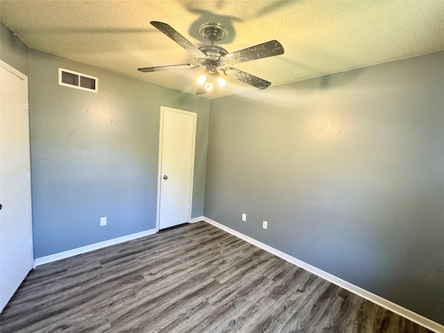 unfurnished bedroom with wood finished floors, a textured ceiling, a ceiling fan, baseboards, and a closet
