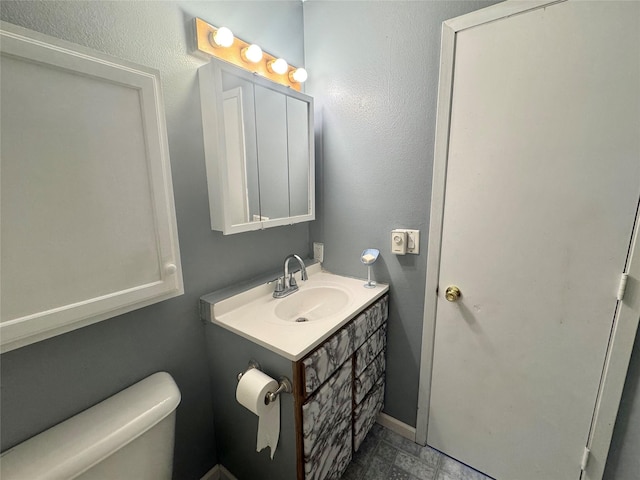 half bathroom with vanity and toilet
