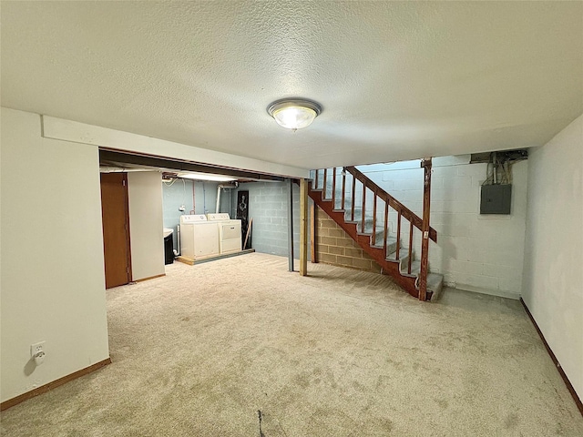 finished below grade area with separate washer and dryer, stairway, electric panel, baseboards, and a textured ceiling