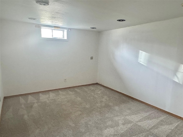 below grade area with carpet and baseboards
