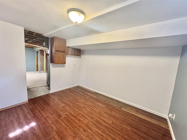 finished basement with dark wood finished floors and baseboards