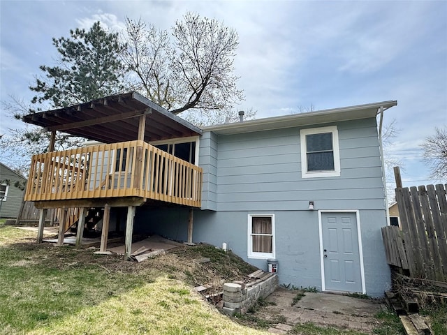 back of house with a wooden deck and fence