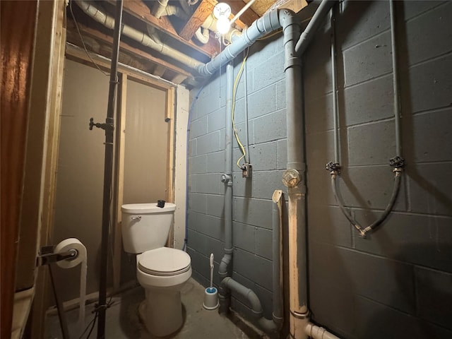 bathroom with toilet and unfinished concrete floors