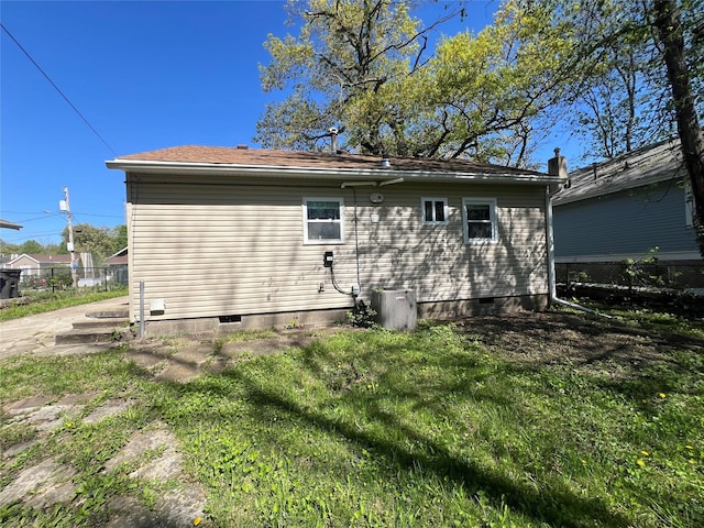 back of property featuring crawl space and central AC