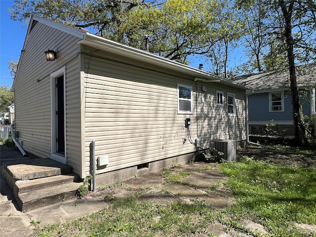 view of home's exterior with cooling unit and fence