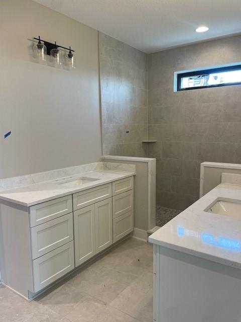 8236 Mahon Ct, Johnston, IA 50131 - full bathroom with two vanities and a walk in shower