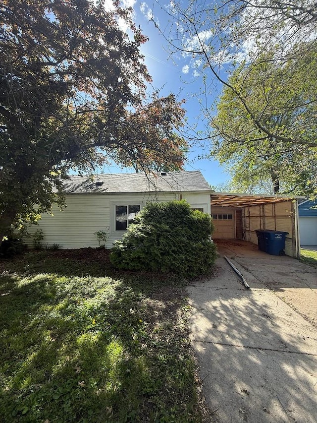 view of home's exterior featuring concrete driveway and an attached garage
