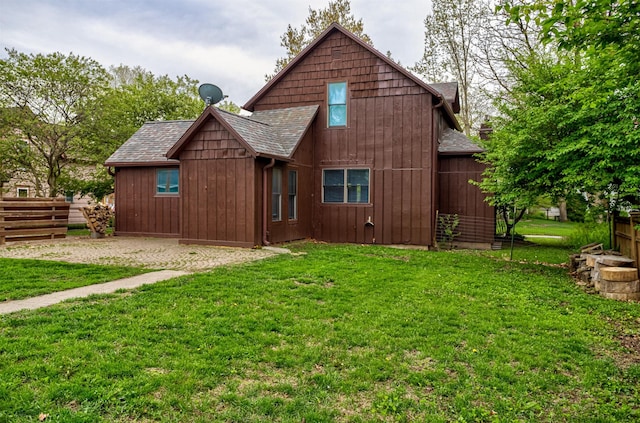 rear view of property featuring roof with shingles