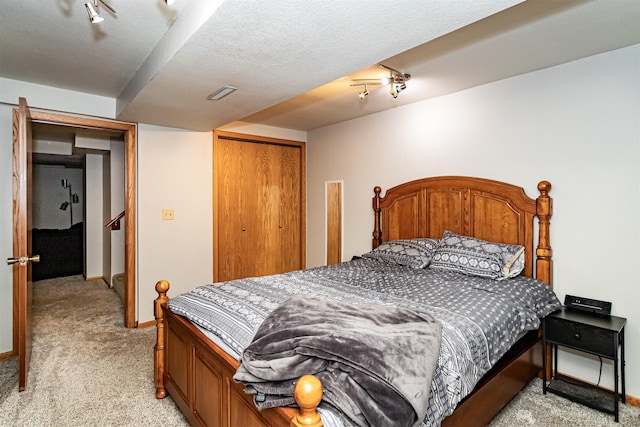 bedroom with light carpet, a closet, and baseboards